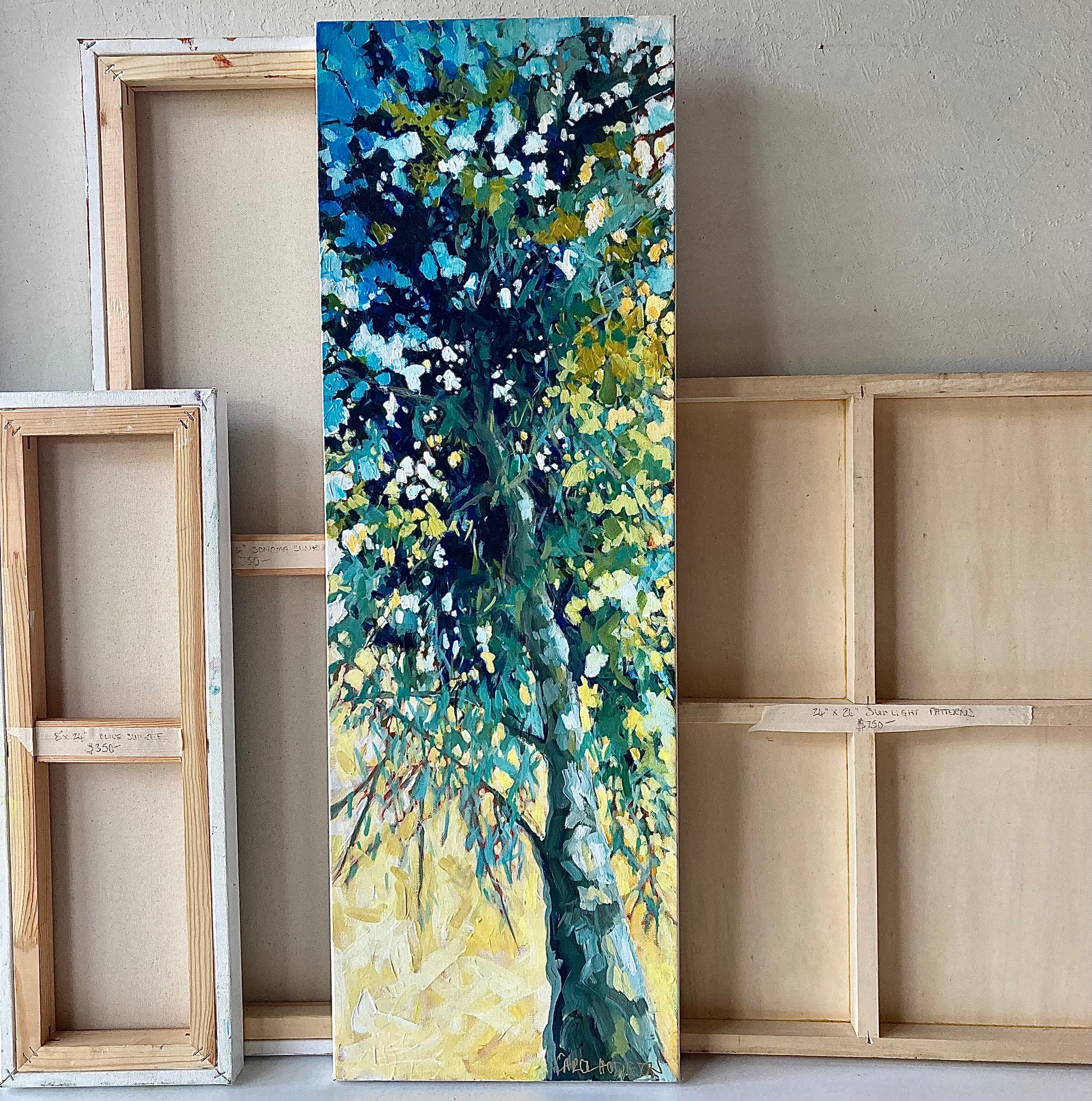 Painting displayed with canvases