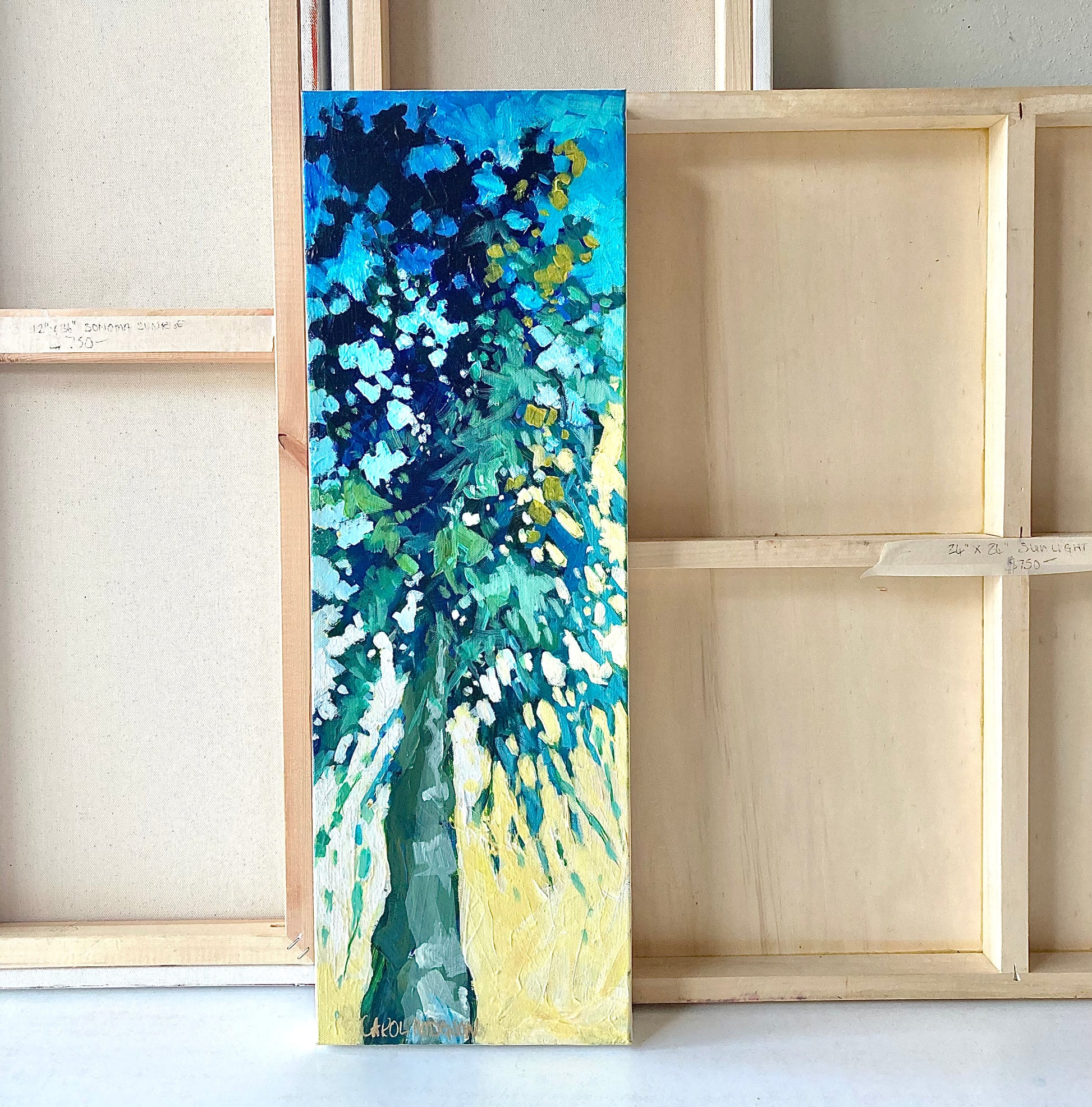 Small olive tree painting with other canvases