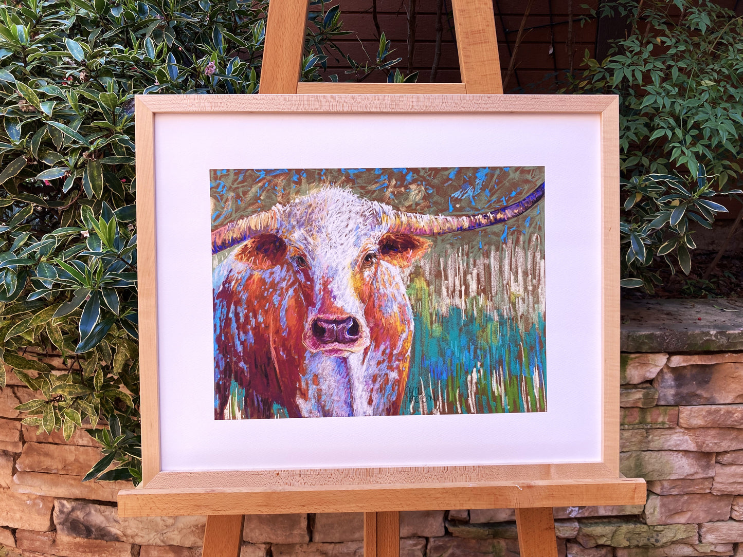 example of cow print in wooden frame.