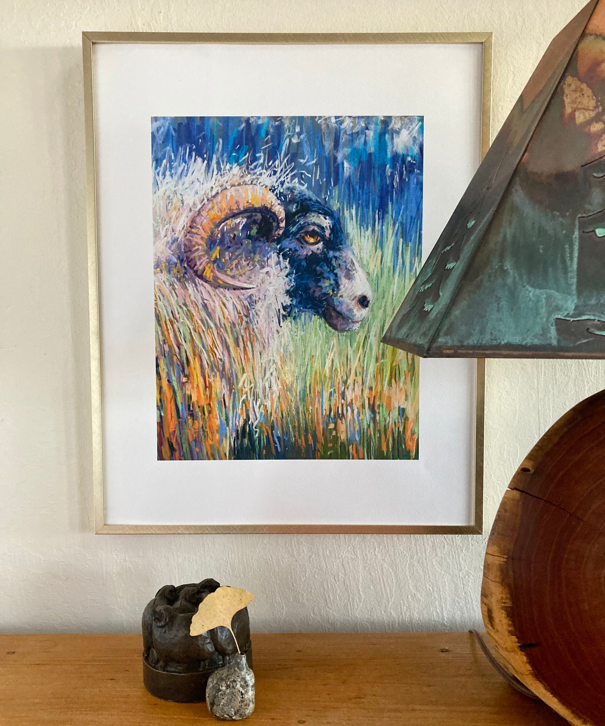 example. Sheep print in gold frame.